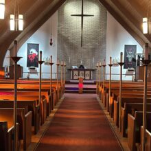 View down Immanuel Lutheran Church’s center aisle toward the altar and cross